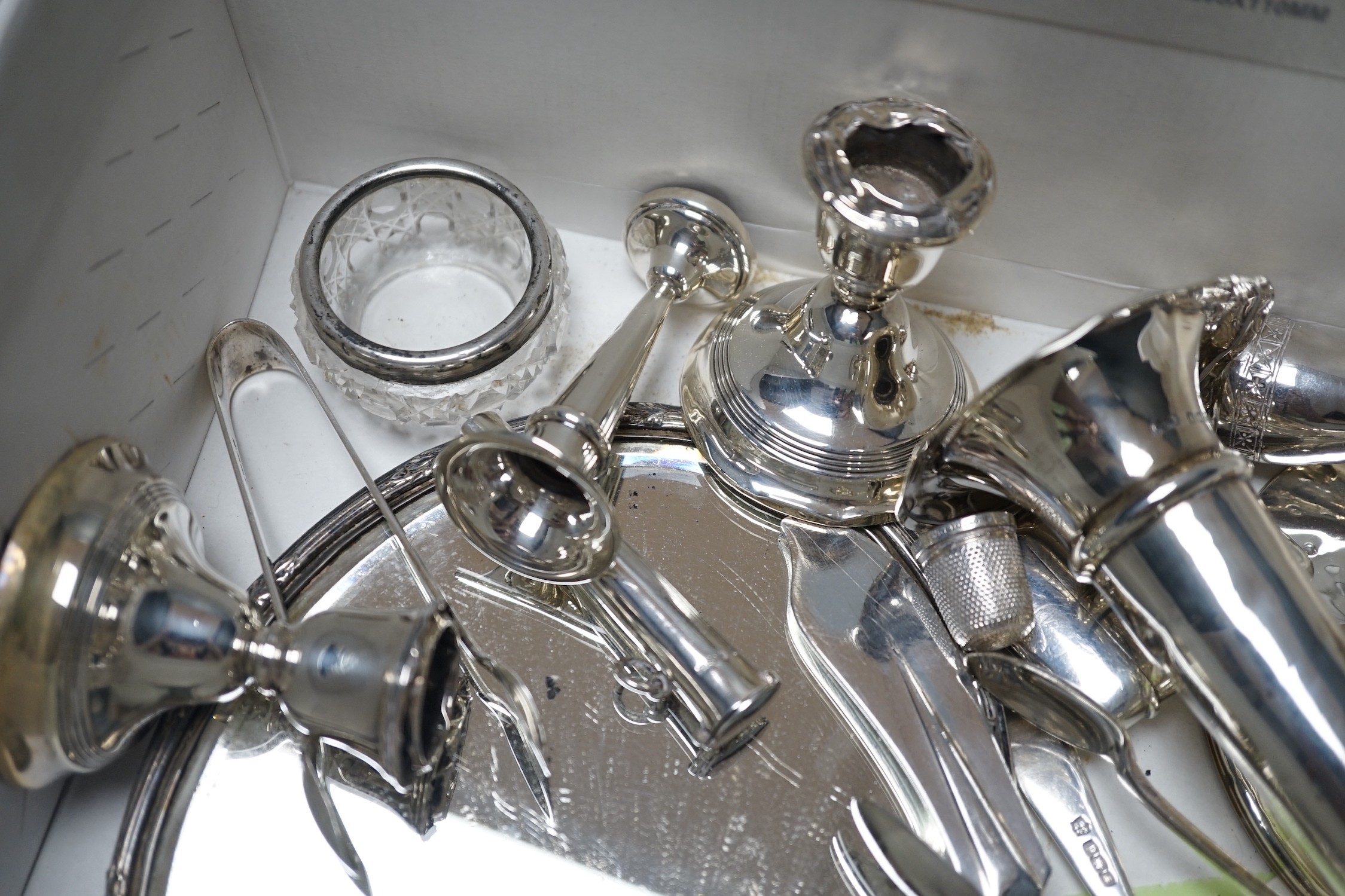 Sundry small silver items including a hand mirror, capstan inkwell, flatware, vesta case, mounted glass salts, dwarf candlesticks, condiments, posy vase, etc.